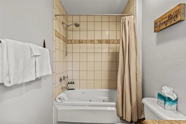 a bathroom with a bathtub and shower