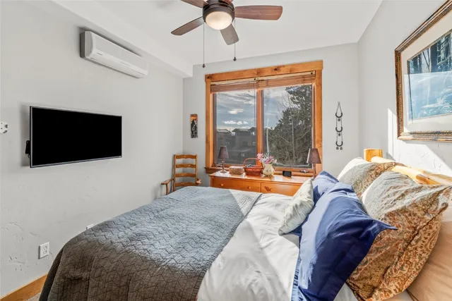 a living room with a bed and a flat screen tv