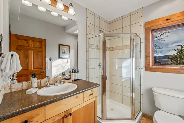 a bathroom with a sink toilet and shower