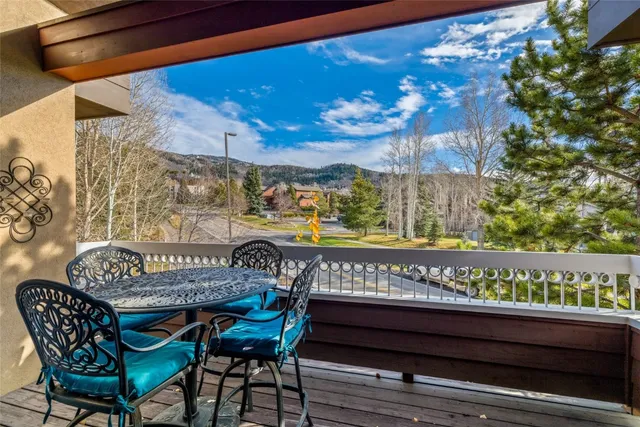 a view of a chairs and table in the balcony