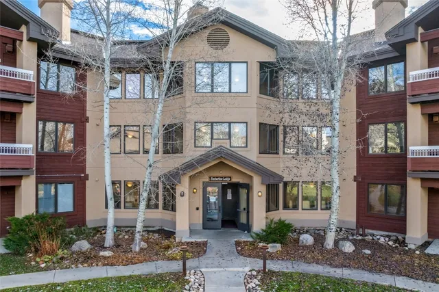 a front view of a residential apartment building with a yard