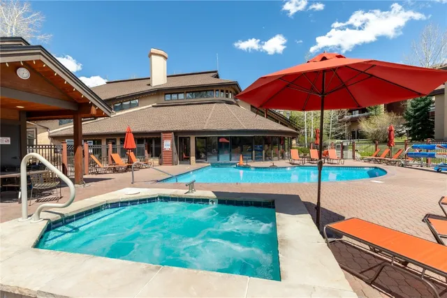 a patio with a table and chairs under an umbrella
