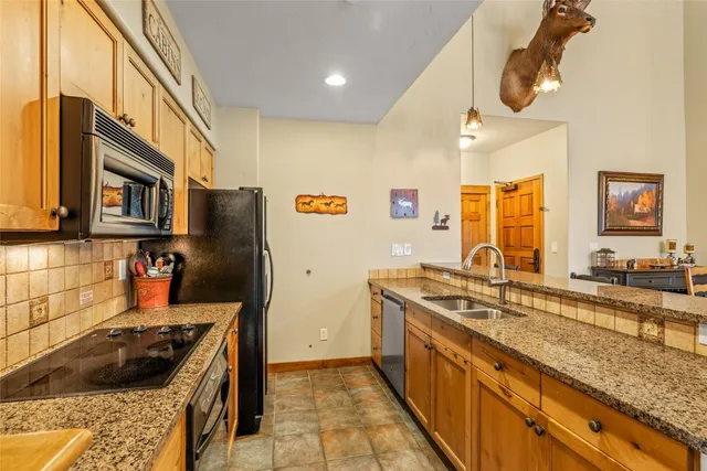 a kitchen with stainless steel appliances granite countertop a sink stove and cabinets