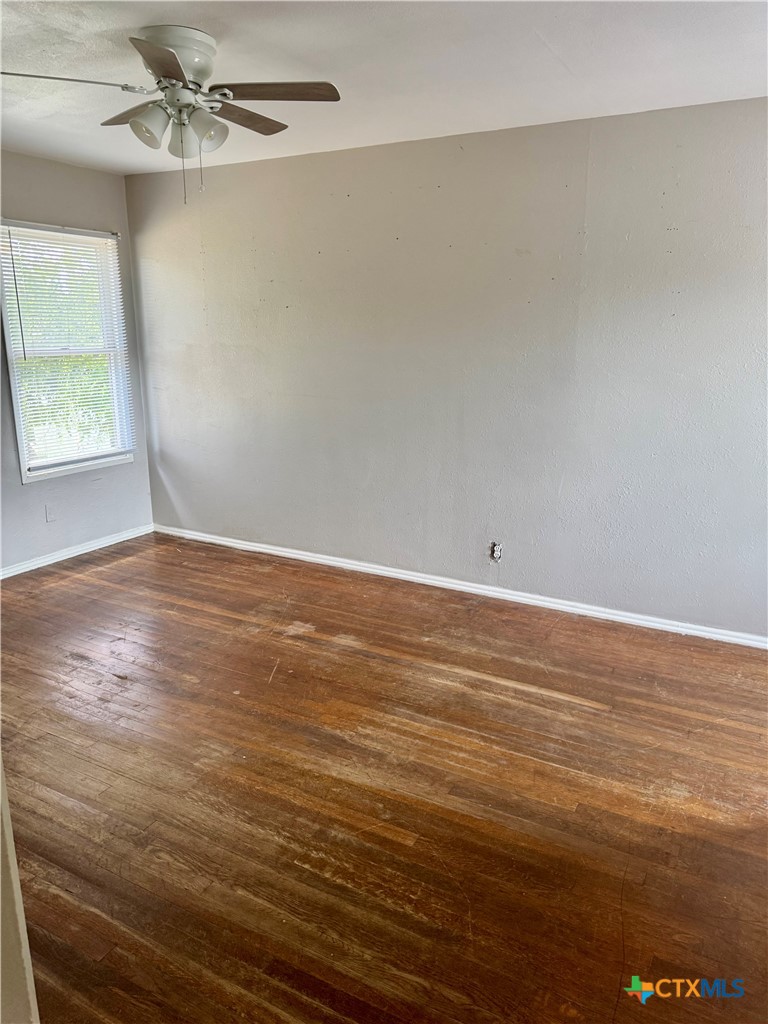 3001 East Rio Grande Street Victoria, TX 77901 - Photo 12 of 20 an empty room with wooden floor fan and windows