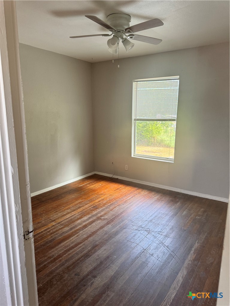 3001 East Rio Grande Street Victoria, TX 77901 - Photo 15 of 20 an empty room with a window and wooden floor