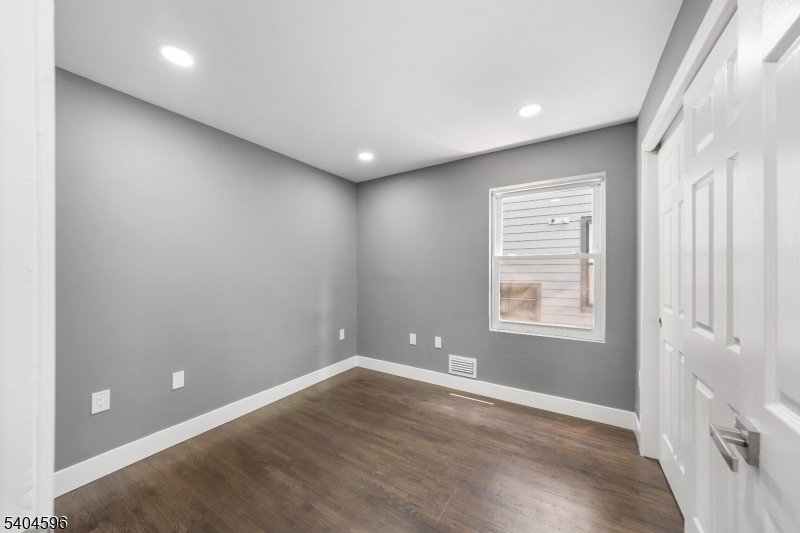 1117 Chestnut Street Elizabeth, NJ 07201 - Photo 12 of 23 an empty room with wooden floor and windows