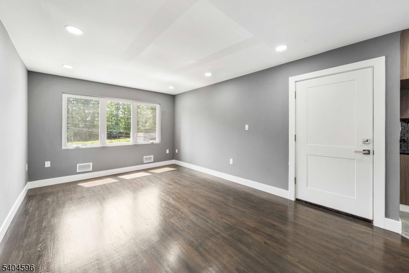 1117 Chestnut Street Elizabeth, NJ 07201 - Photo 16 of 23 an empty room with wooden floor and windows
