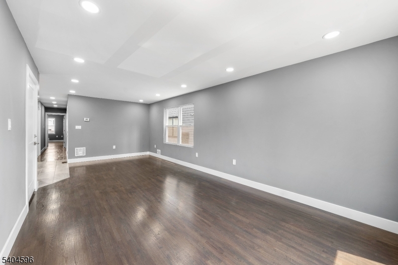 1117 Chestnut Street Elizabeth, NJ 07201 - Photo 18 of 23 a view of an empty room with wooden floor and a window