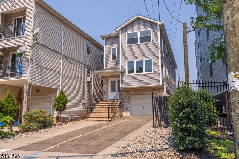 1117 Chestnut Street Elizabeth, NJ 07201 - Photo 23 of 23 a view of a house with a yard and potted plants