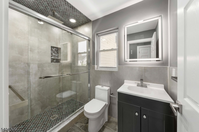 1117 Chestnut Street Elizabeth, NJ 07201 - Photo 8 of 23 a bathroom with a sink toilet and shower