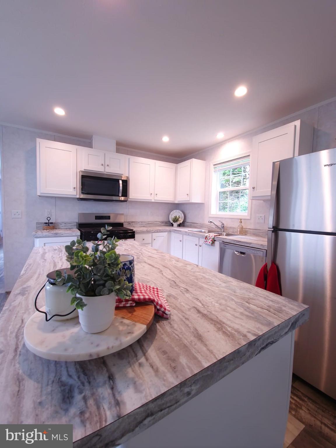 13 Montrose Boulevard Reading, PA 19607 - Photo 11 of 28 a kitchen with kitchen island a stove a sink and a refrigerator