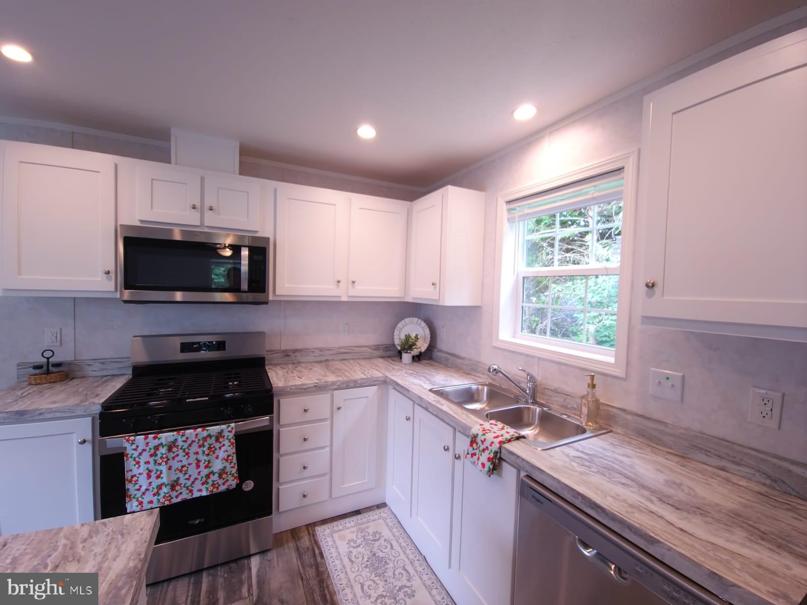 13 Montrose Boulevard Reading, PA 19607 - Photo 10 of 28 a kitchen with granite countertop a sink a stove a microwave and cabinets