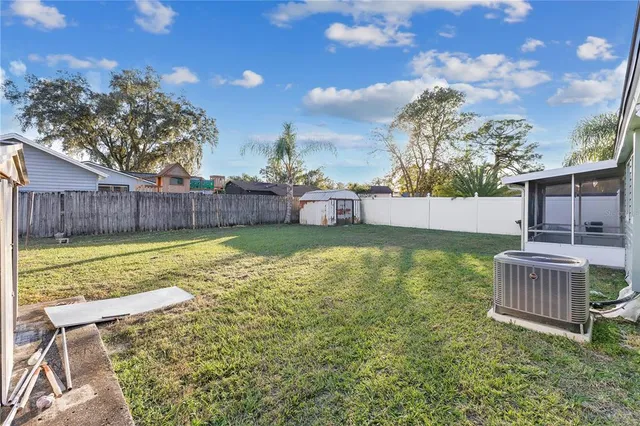 a view of a backyard with a garden and fire pit