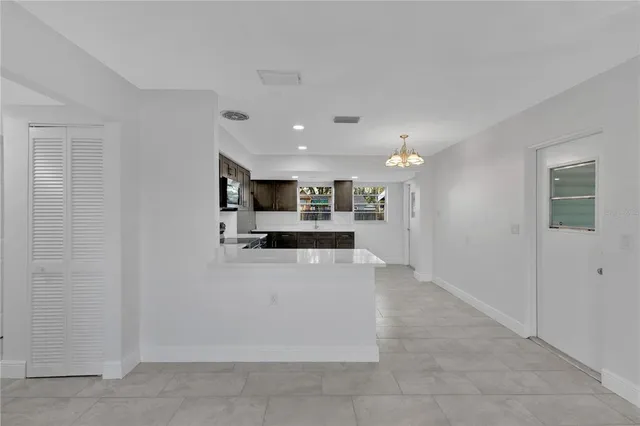 a view of kitchen with stainless steel appliances kitchen island sink refrigerator and stove