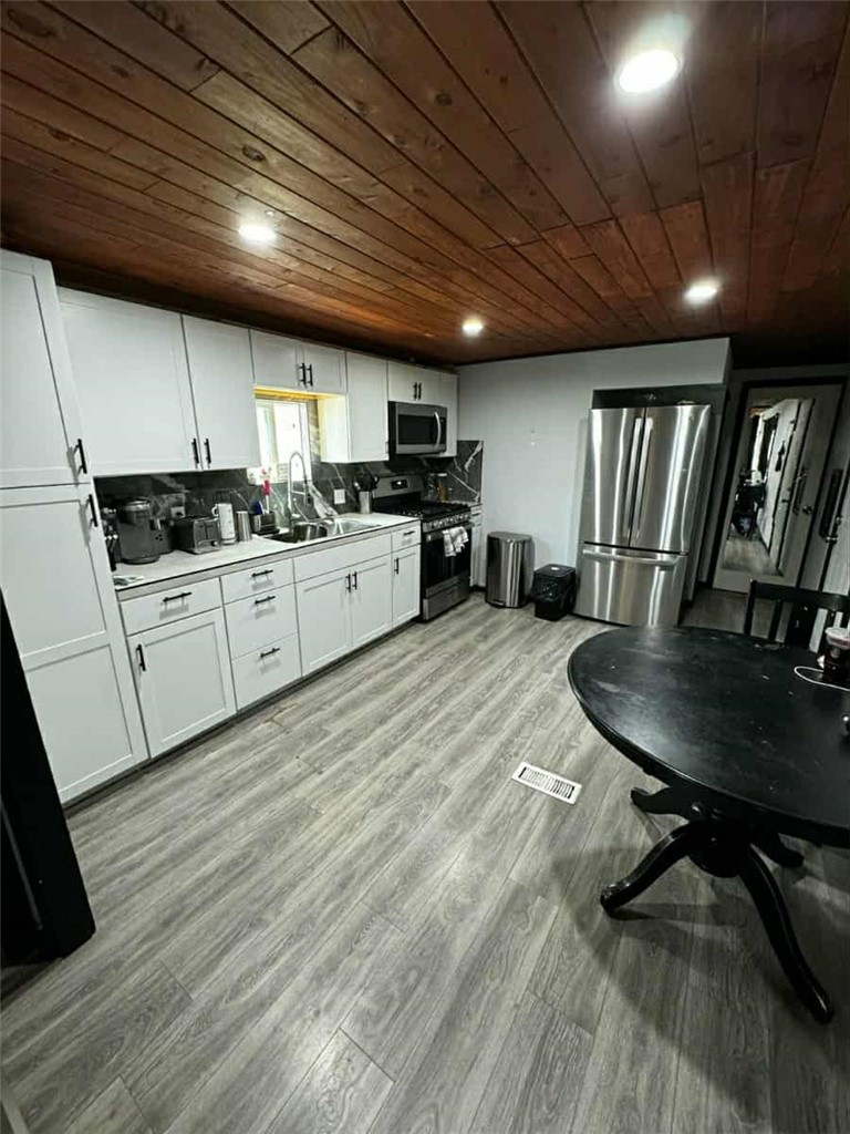 657 Lebec Road, Unit 27 Lebec, CA 93243 - Photo 3 of 6 a kitchen with granite countertop a sink stainless steel appliances and wooden cabinets