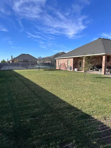 a kitchen with a stove a kitchen island a dining table and chairs
