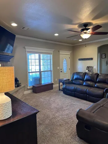 a bedroom with a bed and a flat tv screen on dresser