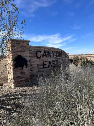 a front view of a house with a garden and trees