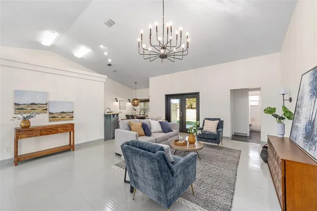 a living room with furniture and a chandelier
