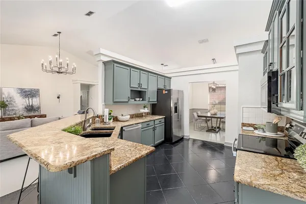a kitchen with sink refrigerator and cabinets