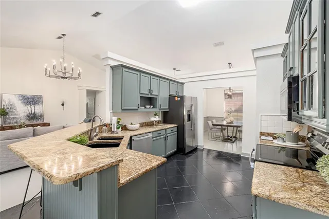 a kitchen with sink refrigerator and cabinets