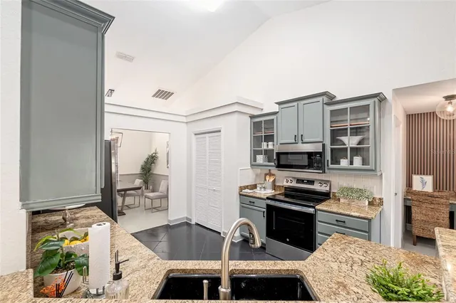 a kitchen that has a sink and a stove in it