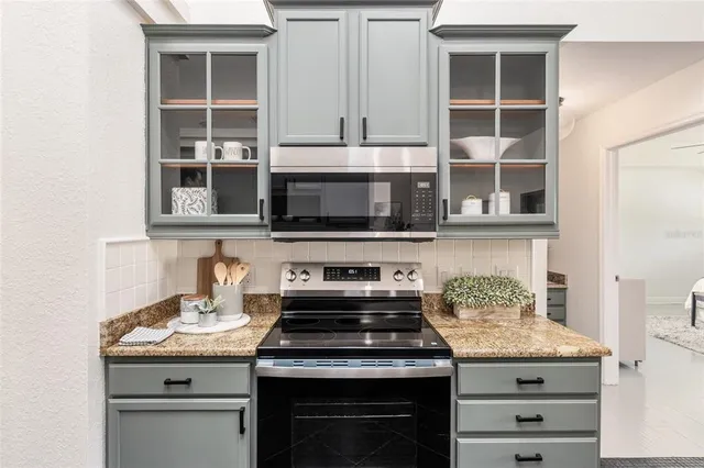 a kitchen with stainless steel appliances granite countertop a stove and a microwave