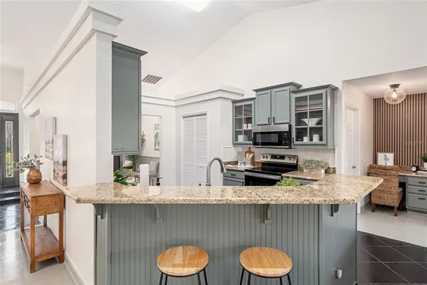 a kitchen with a sink a stove and cabinets