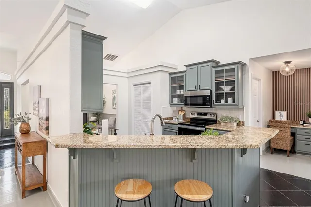 a kitchen with a sink a stove and cabinets