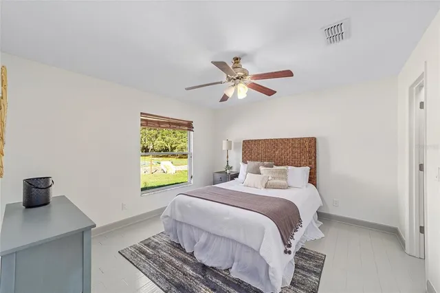 a bedroom with a bed and a window