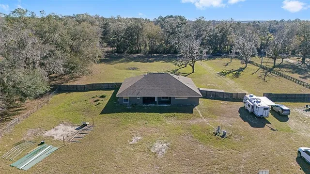 a view of a backyard with swimming pool