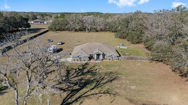 an aerial view of a house with a yard