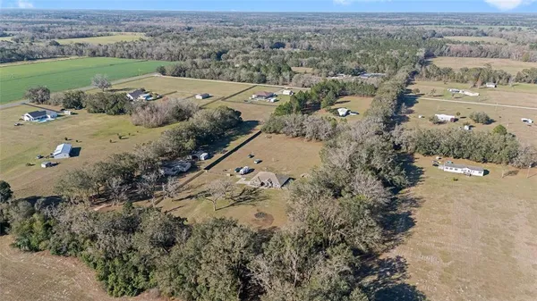 a view of a big yard with lots of green space