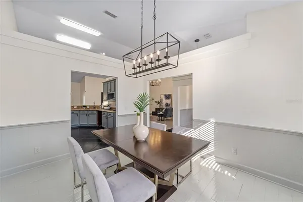 a view of a dining room with furniture and chandelier