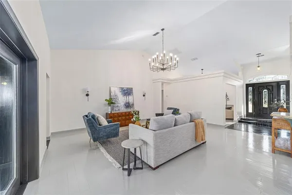 a living room with furniture and a chandelier