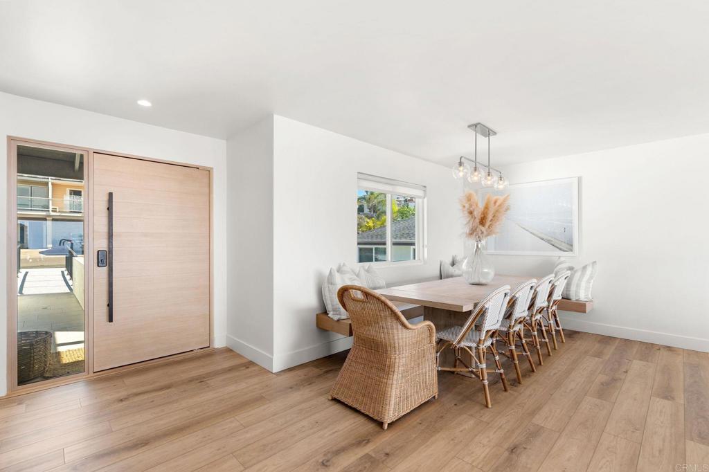 2172 Oxford Avenue Cardiff-by-the-Sea, CA 92007 - Photo 11 of 68 an open kitchen with dining table and wooden floor