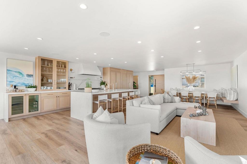 2172 Oxford Avenue Cardiff-by-the-Sea, CA 92007 - Photo 13 of 68 a living room with stainless steel appliances kitchen island granite countertop a couch and white cabinets