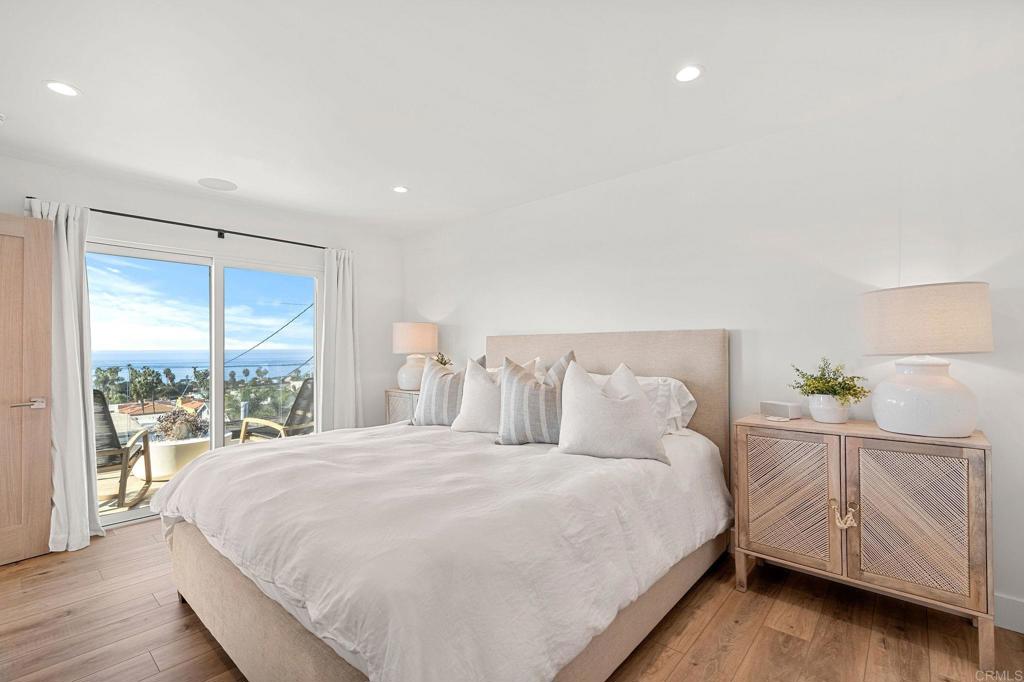 2172 Oxford Avenue Cardiff-by-the-Sea, CA 92007 - Photo 14 of 68 a large bed sitting in a bedroom next to a lamp