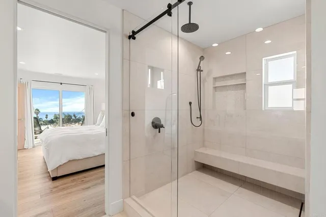 front view of a house with a bench and potted plants