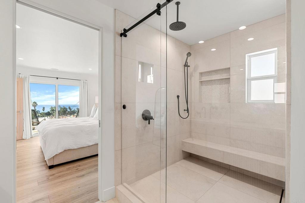 2172 Oxford Avenue Cardiff-by-the-Sea, CA 92007 - Photo 18 of 68 a spacious bathroom with a glass shower door and a bathtub