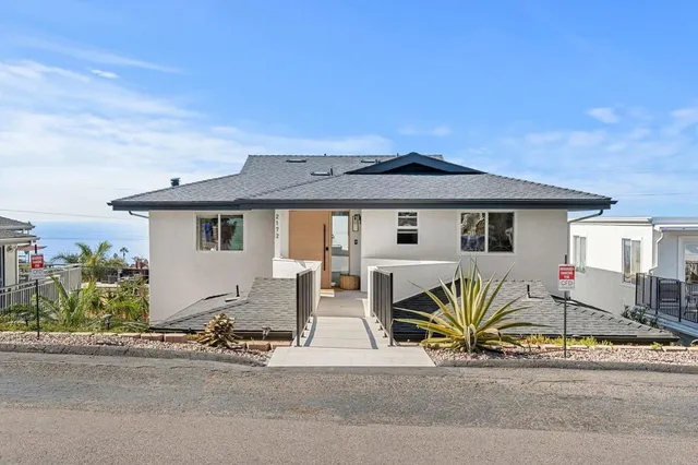 a large white bed in a white room