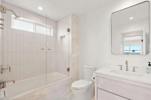 a kitchen with cabinets and wooden floor