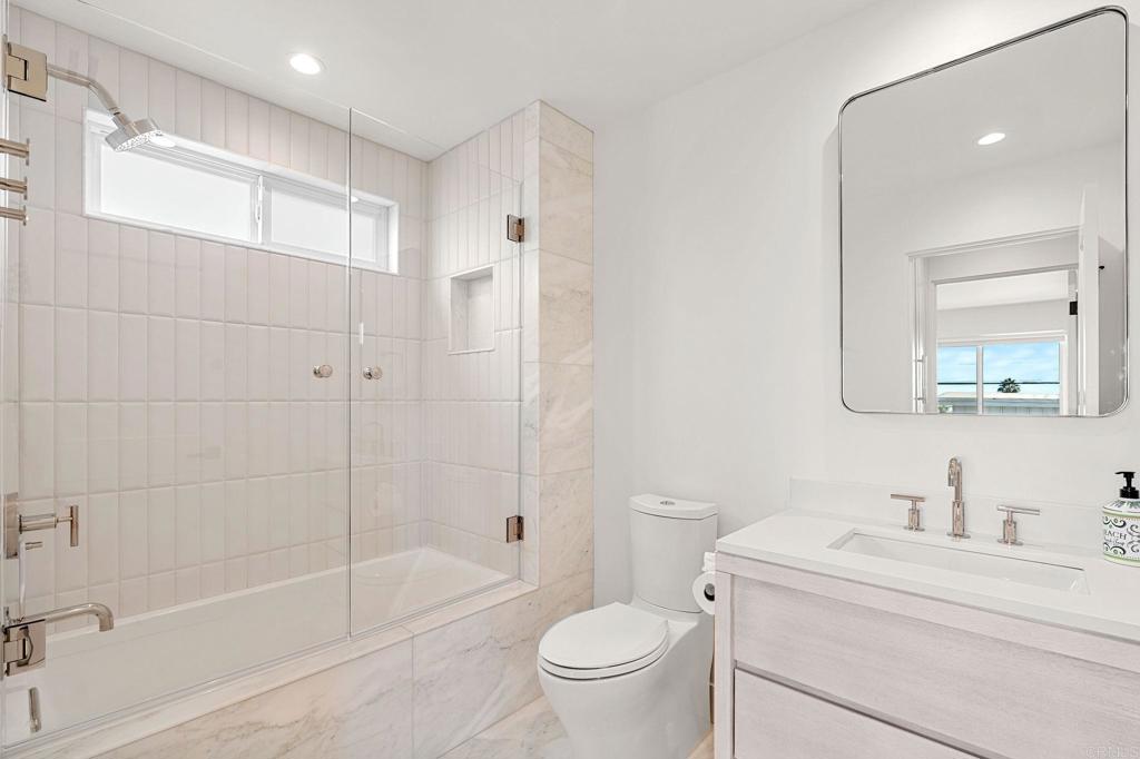2172 Oxford Avenue Cardiff-by-the-Sea, CA 92007 - Photo 30 of 68 a bathroom with a granite countertop sink a toilet and shower