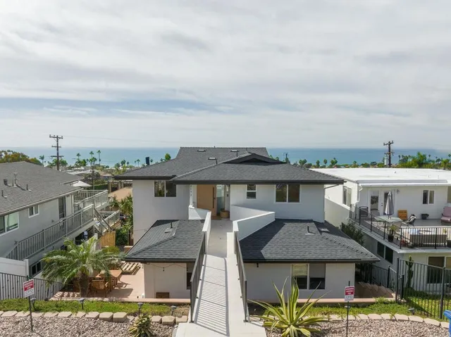 a living room with furniture a potted plant and a table