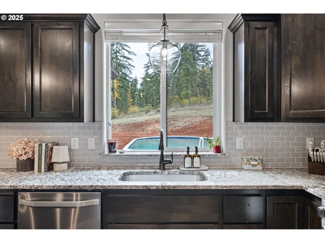 a kitchen with granite countertop a sink and a window