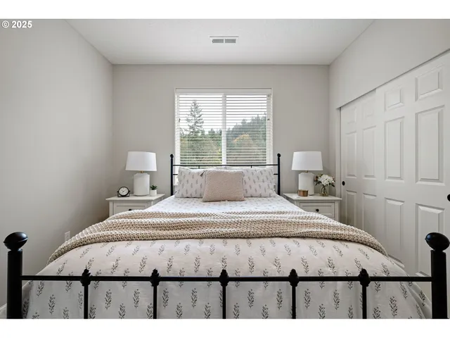 a spacious bedroom with a bed a couch and a window