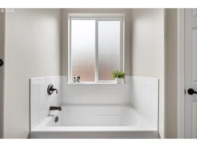 a bathroom with a refrigerator and a sink