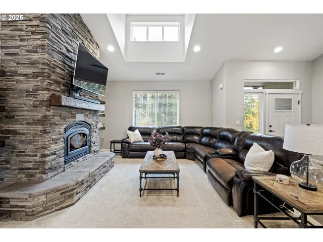 a living room with furniture a fireplace and a flat screen tv