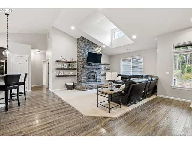 a living room with furniture flat screen tv and a fireplace