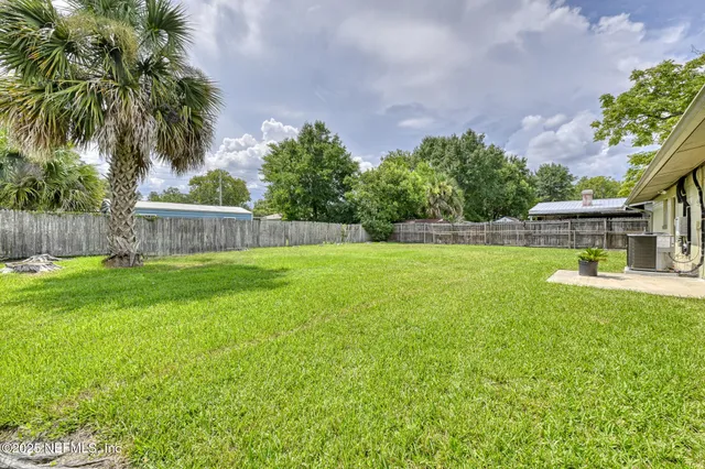 a view of a house with a yard and a garden